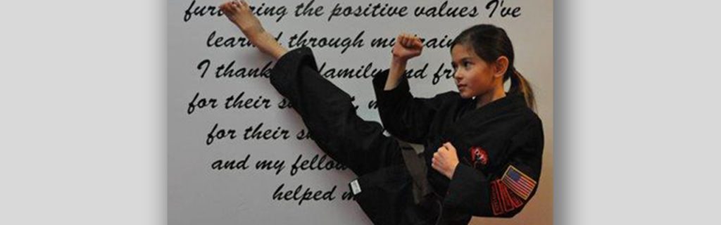 Young girl doing Karate kick