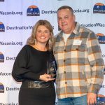 A women presenting a man with award