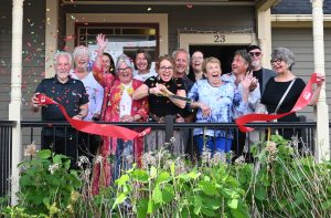 Group at a ribbon cutting with confetti