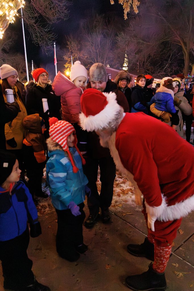 Santa bending down talking to a little girl